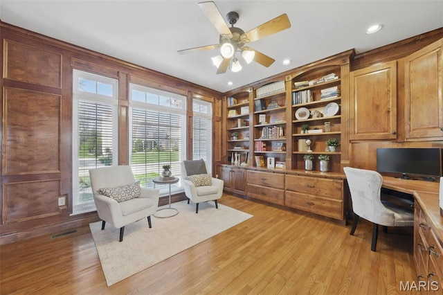 office space featuring built in desk, ceiling fan, light wood-style flooring, and recessed lighting