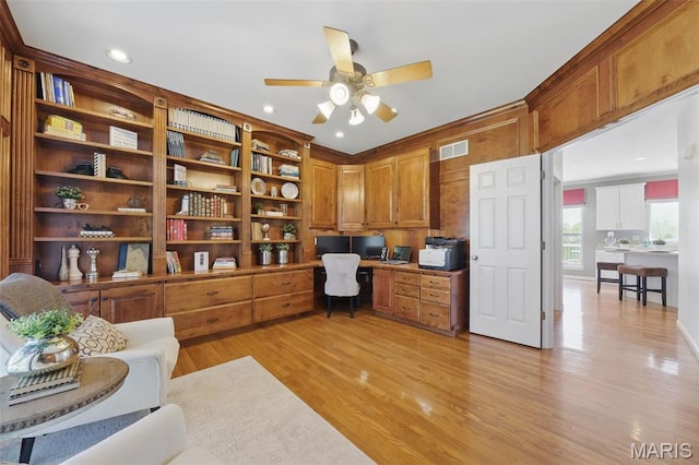 office with built in desk, a ceiling fan, light wood finished floors, and recessed lighting