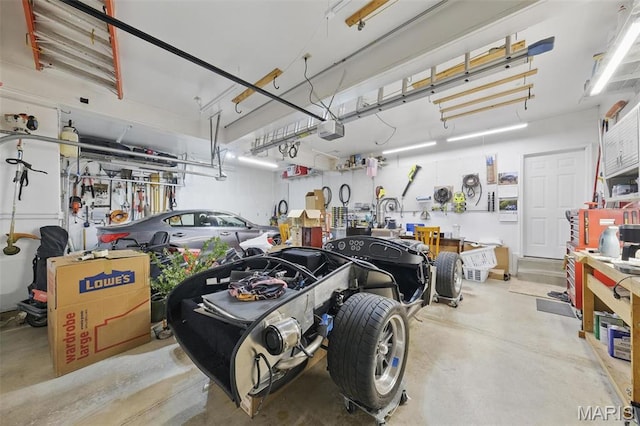 garage with a garage door opener and a workshop area