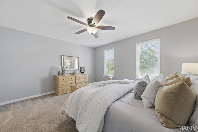 bedroom with baseboards, light colored carpet, and a ceiling fan