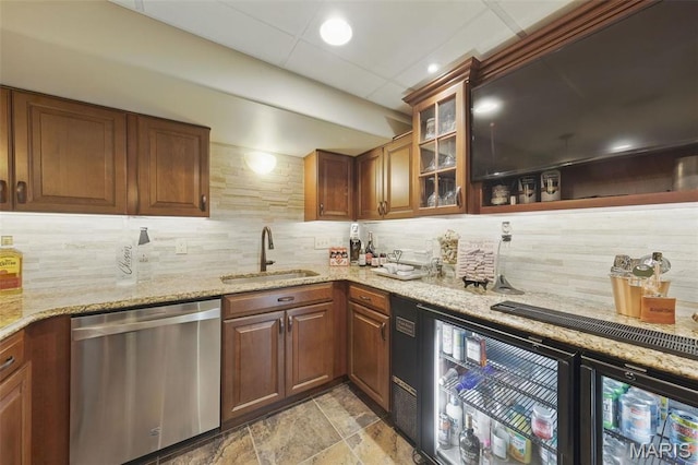 indoor wet bar featuring dishwasher, tasteful backsplash, and light stone finish floors