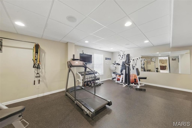 workout room featuring a paneled ceiling, baseboards, and recessed lighting