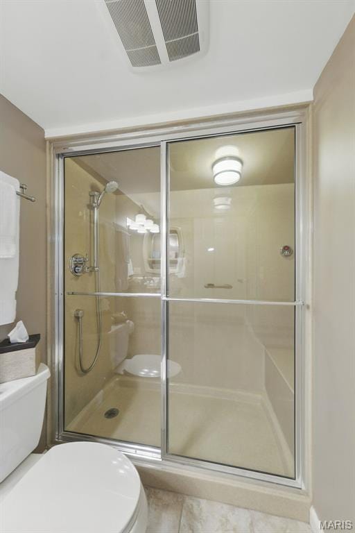 full bath featuring toilet and a stall shower