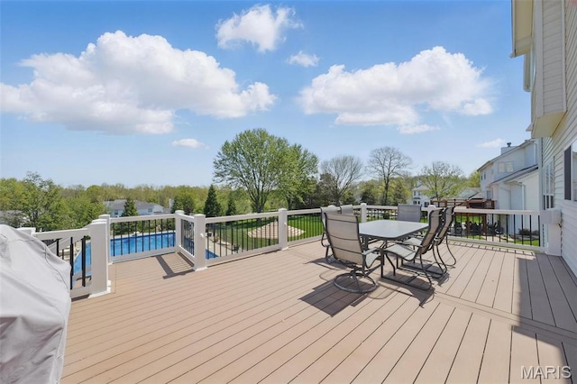 wooden terrace with outdoor dining space