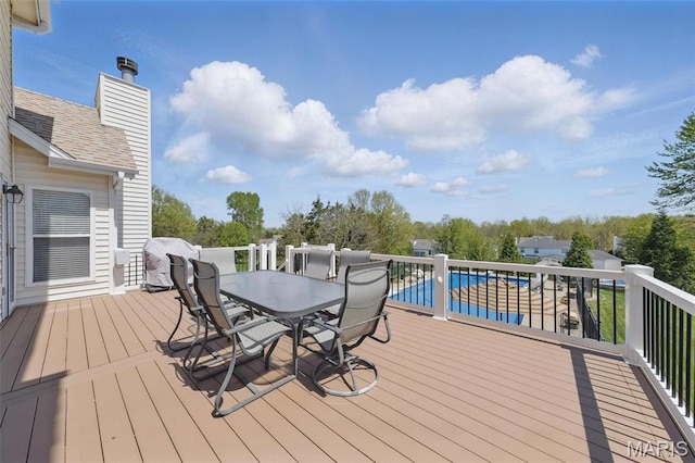 deck with a grill and outdoor dining area