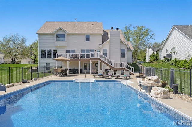 view of pool featuring stairs, a patio, a fenced backyard, and central AC