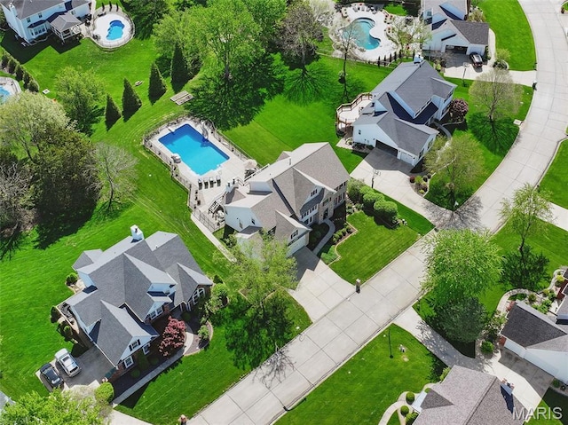 aerial perspective of suburban area featuring a pool