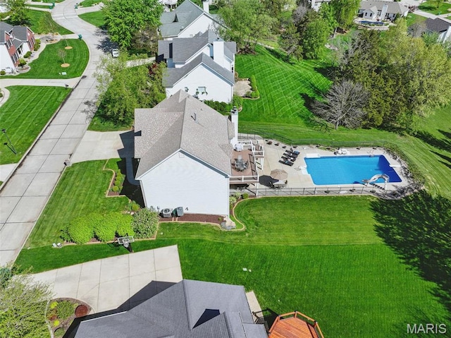 aerial perspective of suburban area featuring a pool