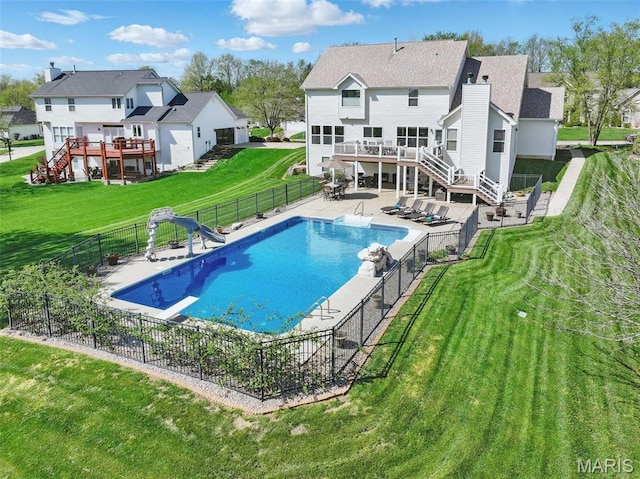 view of swimming pool featuring stairs, a wooden deck, a patio, and a water slide