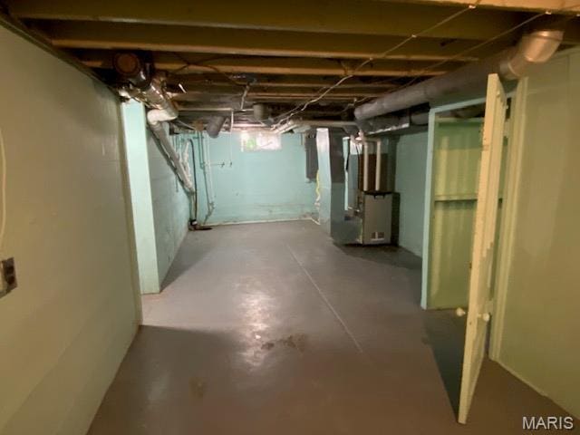 unfinished basement featuring heating unit