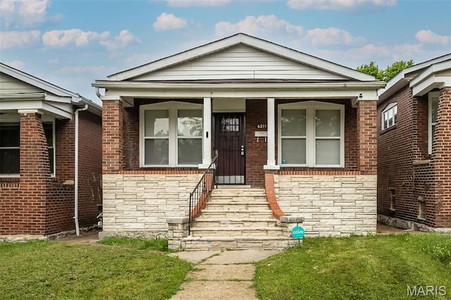 6211 Idaho Ave, Saint Louis, MO 63111 - view of front facade with stone siding, a front lawn, and brick siding