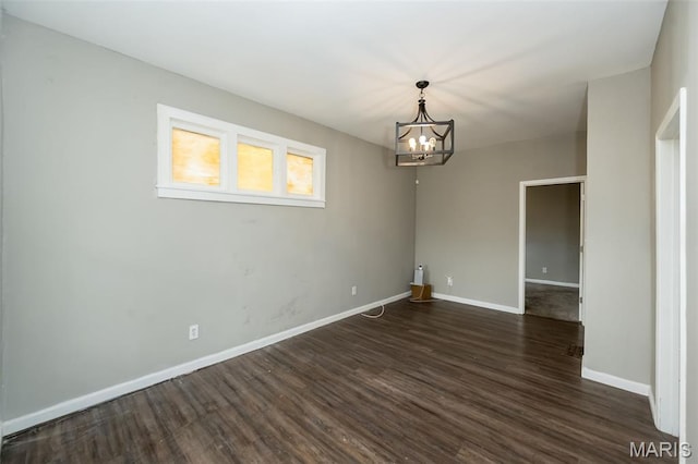 6211 Idaho Ave, Saint Louis, MO 63111 - empty room featuring dark wood-style floors, a chandelier, and baseboards