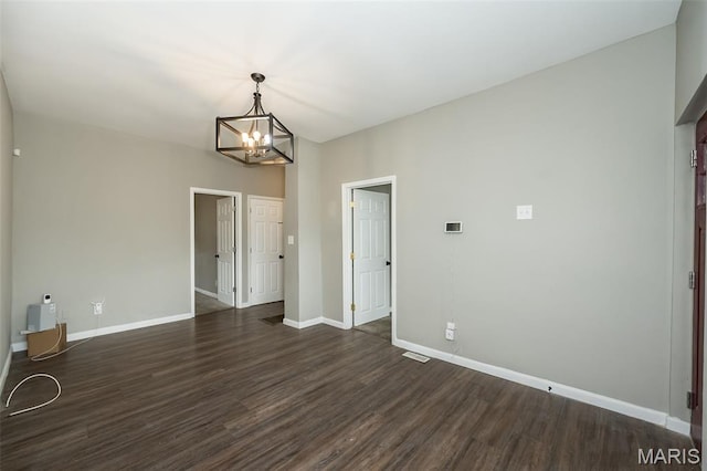 6211 Idaho Ave, Saint Louis, MO 63111 - empty room featuring dark wood-style flooring, a chandelier, and baseboards