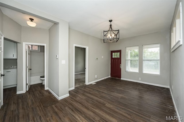 6211 Idaho Ave, Saint Louis, MO 63111 - entrance foyer featuring a chandelier, dark wood finished floors, and baseboards