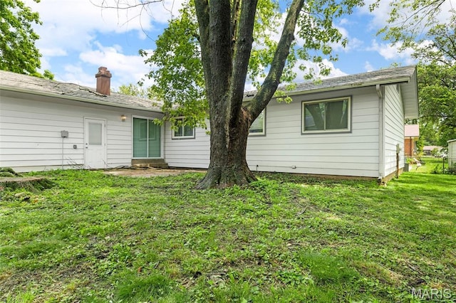1455 Burnside Ct, Florissant, MO 63031 - back of property featuring a yard and a chimney