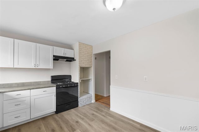 1455 Burnside Ct, Florissant, MO 63031 - kitchen with black range with gas stovetop, under cabinet range hood, light wood-style floors, and white cabinetry