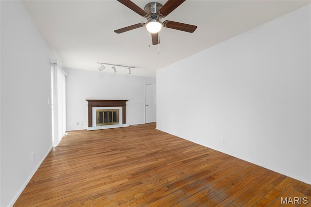 1455 Burnside Ct, Florissant, MO 63031 - unfurnished living room with wood-type flooring, ceiling fan, a brick fireplace, and rail lighting