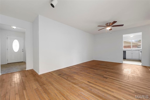 1455 Burnside Ct, Florissant, MO 63031 - unfurnished living room with a ceiling fan, plenty of natural light, light wood finished floors, and a sink