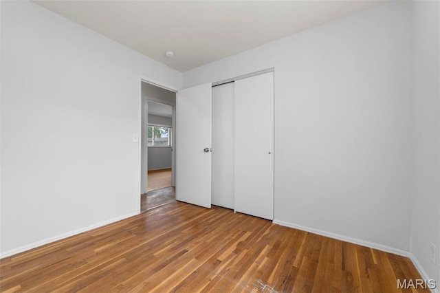 1455 Burnside Ct, Florissant, MO 63031 - unfurnished bedroom with light wood-type flooring, a closet, and baseboards