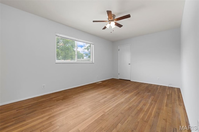 1455 Burnside Ct, Florissant, MO 63031 - spare room featuring light wood-style floors, ceiling fan, and baseboards