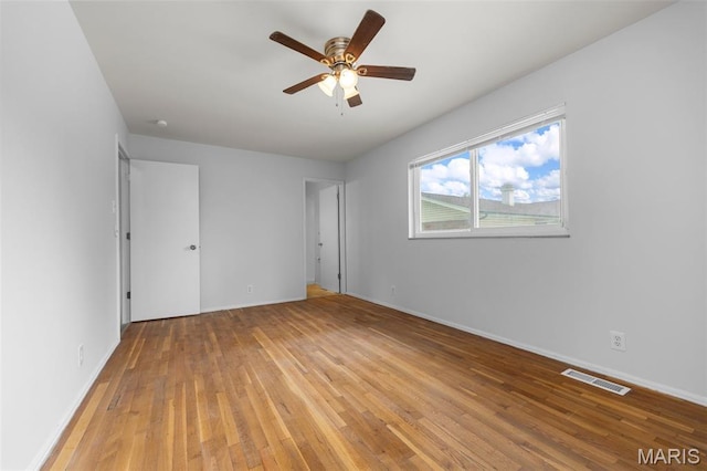 1455 Burnside Ct, Florissant, MO 63031 - unfurnished bedroom with light wood finished floors, baseboards, and a ceiling fan