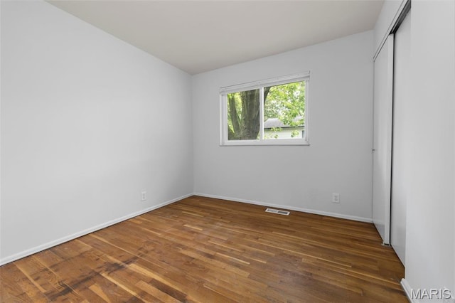 1455 Burnside Ct, Florissant, MO 63031 - unfurnished bedroom featuring wood finished floors, baseboards, and a closet