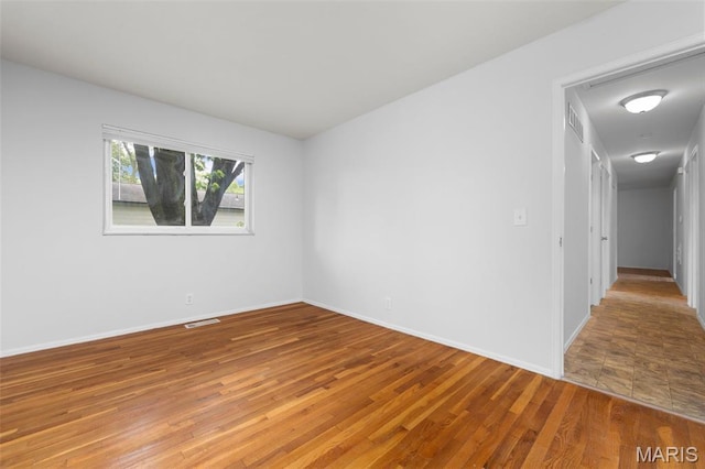 1455 Burnside Ct, Florissant, MO 63031 - spare room featuring wood finished floors and baseboards