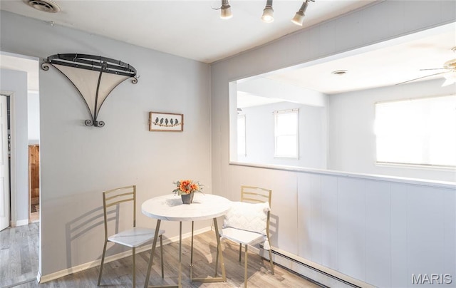 11 Saint Ann Ave, St James, MO 65559 - dining area with wood finished floors, a baseboard heating unit, and a ceiling fan