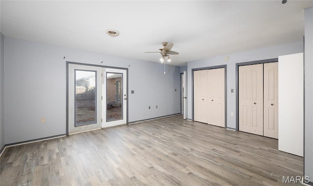 11 Saint Ann Ave, St James, MO 65559 - unfurnished bedroom featuring multiple closets, light wood-style flooring, baseboards, and a ceiling fan