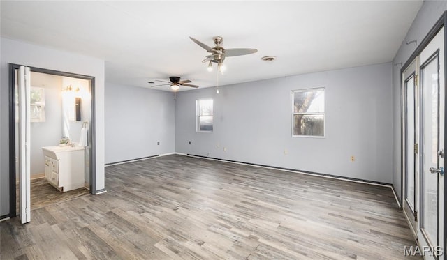 11 Saint Ann Ave, St James, MO 65559 - unfurnished bedroom featuring multiple windows, light wood finished floors, baseboards, and ensuite bath