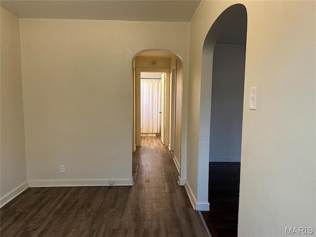 127 Whitelaw Ave, East Alton, IL 62024 - hallway featuring dark wood-type flooring, arched walkways, and baseboards