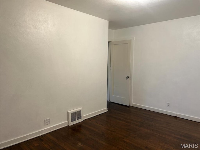 127 Whitelaw Ave, East Alton, IL 62024 - unfurnished room featuring dark wood-type flooring and baseboards