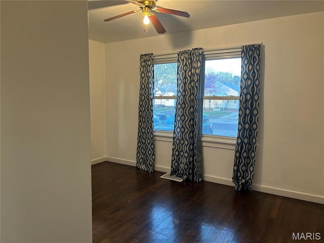 127 Whitelaw Ave, East Alton, IL 62024 - spare room with dark wood-type flooring, ceiling fan, and baseboards