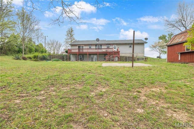 back of house with a deck