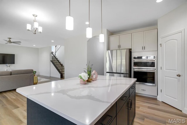 536 Edison Way, Wentzville, MO 63385 - kitchen with stainless steel appliances, light wood-type flooring, decorative light fixtures, a chandelier, and recessed lighting