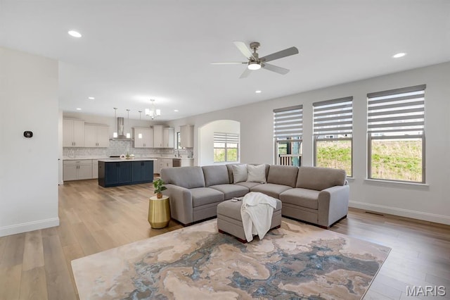 536 Edison Way, Wentzville, MO 63385 - living area featuring arched walkways, ceiling fan, light wood-style floors, recessed lighting, and baseboards