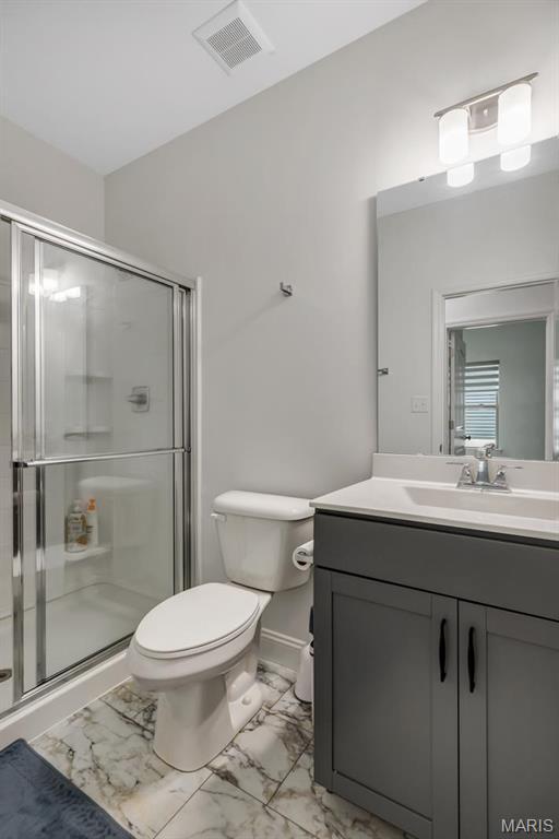 536 Edison Way, Wentzville, MO 63385 - full bath with marble finish flooring, a stall shower, vanity, and toilet