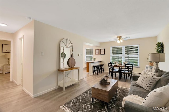 1707 Mayenne Ct Unit B, Saint Louis, MO 63125 - living area featuring a ceiling fan, light wood-style floors, and baseboards