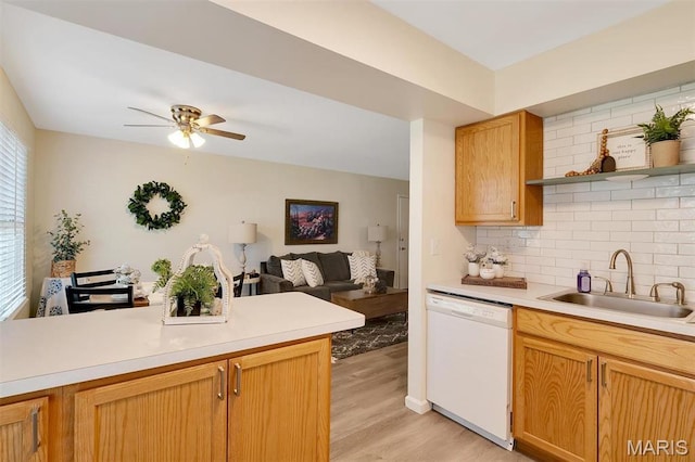 1707 Mayenne Ct Unit B, Saint Louis, MO 63125 - kitchen with white dishwasher, a sink, decorative backsplash, light wood-style flooring, and light countertops