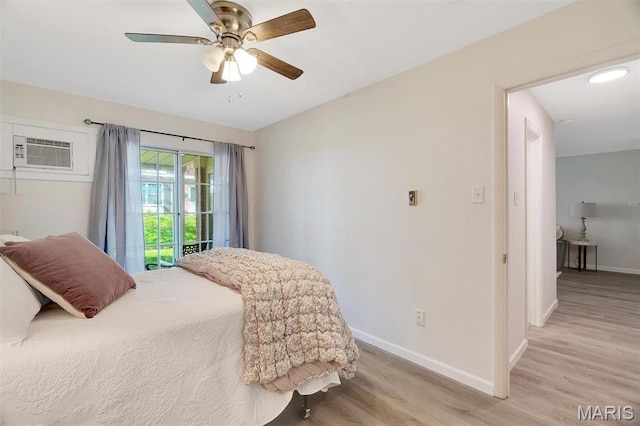 1707 Mayenne Ct Unit B, Saint Louis, MO 63125 - bedroom with light wood-style floors, baseboards, a wall unit AC, access to outside, and a ceiling fan