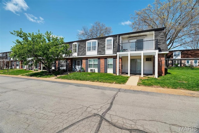 1707 Mayenne Ct Unit B, Saint Louis, MO 63125 - townhome / multi-family property featuring a balcony, brick siding, and a front yard