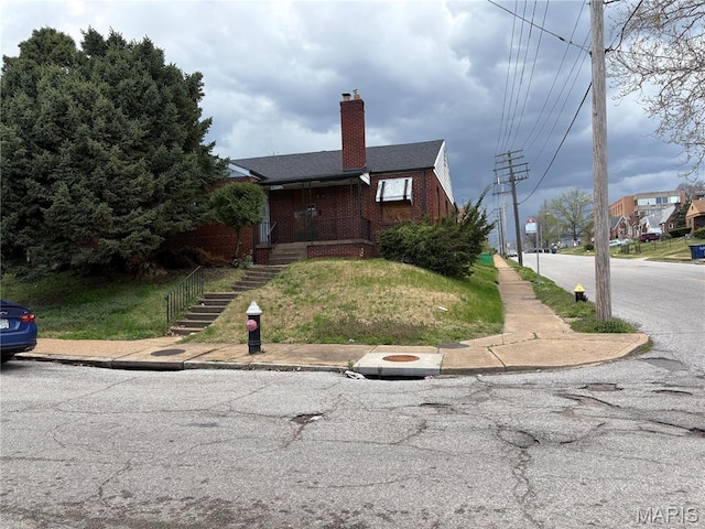 8459 Newby St, Saint Louis, MO 63147 - view of front facade with brick siding and a chimney
