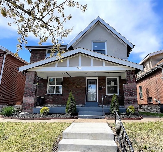 5811 Dewey Ave, Saint Louis, MO 63116 - view of front of house with a porch, brick siding, and a front yard