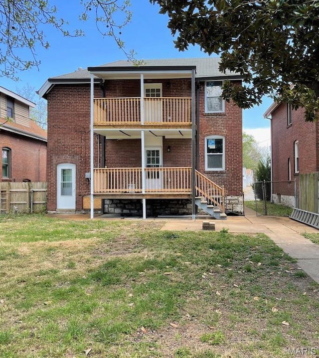 5811 Dewey Ave, Saint Louis, MO 63116 - back of house with a balcony, brick siding, and a wooden deck