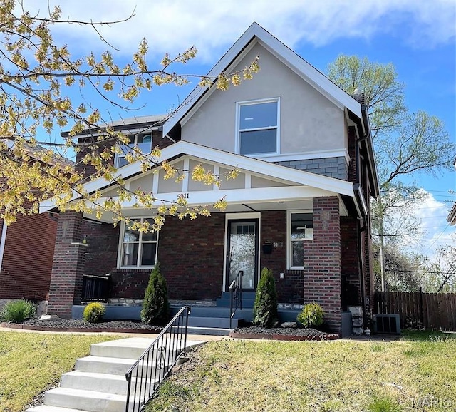 5811 Dewey Ave, Saint Louis, MO 63116 - view of front of property featuring a porch, brick siding, stucco siding, and central AC