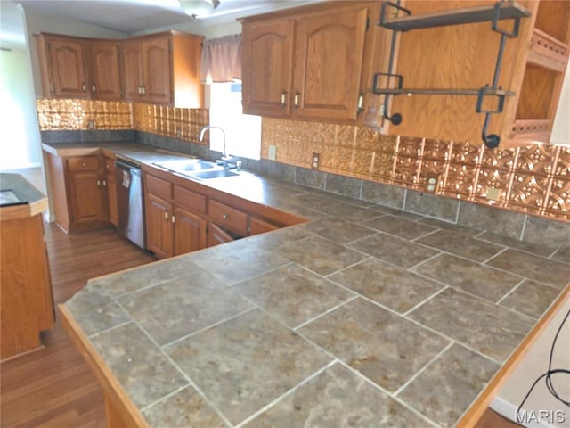 kitchen featuring a sink, brown cabinets, stainless steel dishwasher, and wood finished floors