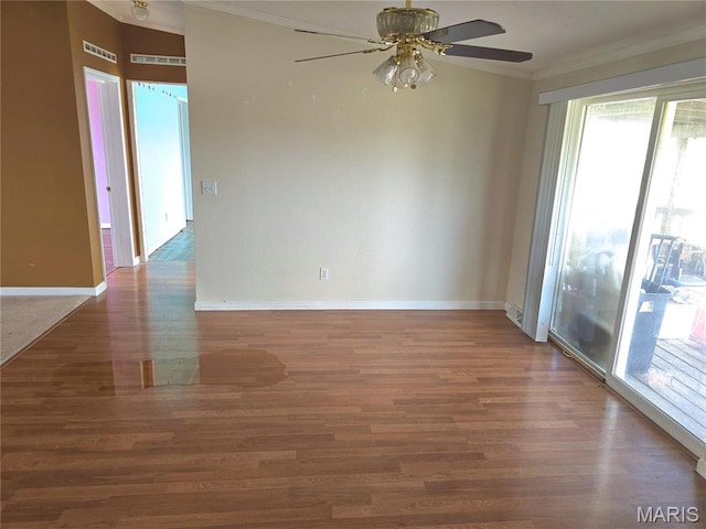 unfurnished room featuring ornamental molding, plenty of natural light, ceiling fan, and wood finished floors