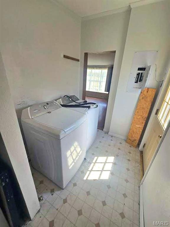 washroom with washing machine and clothes dryer, crown molding, electric panel, and light flooring