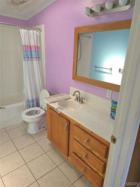 full bathroom featuring tile patterned floors, vanity, toilet, and shower / tub combo with curtain