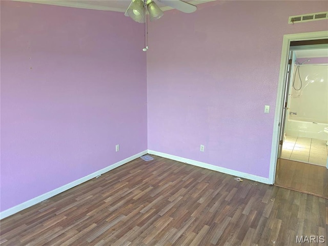 spare room with wood finished floors, baseboards, and ceiling fan